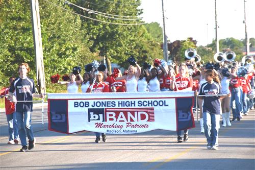 marching band banner with band members behind
